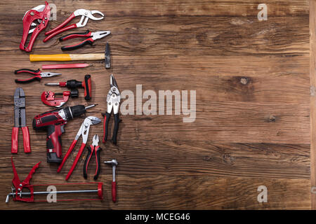 Elevated View Of Various Worktools On Wooden Desk Stock Photo