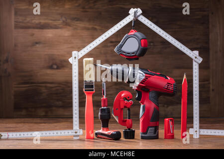 Close-up Of Repairs Tools Under The House Made With Measuring Tape On The Wooden Table Stock Photo