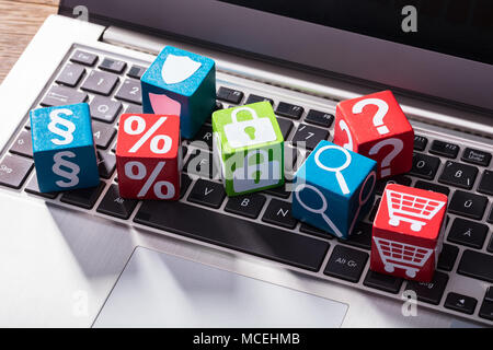 Elevated View Of Social Symbols On Wooden Block Over The Laptop Keypad Stock Photo