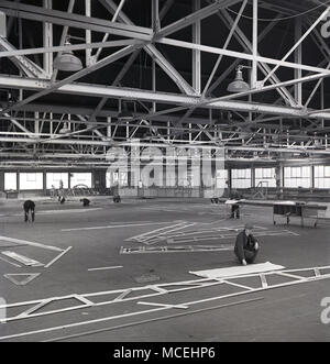 1950s, historical, workers in a large low-level aviation hangar at the Short Bros aircraft company, Belfast, Northern Ireland. Stock Photo