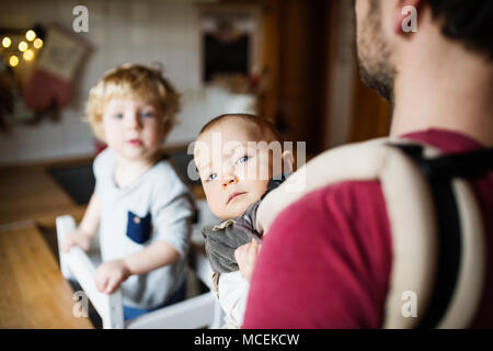 Father with two toddlers at home. Stock Photo