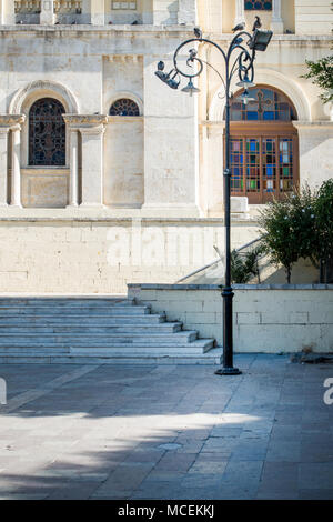 Street light on footpath in front of building, Heraklion, Greece Stock Photo