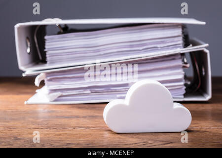 Close-up Of Clouds Block In Front Of Folders On The Wooden Table Stock Photo