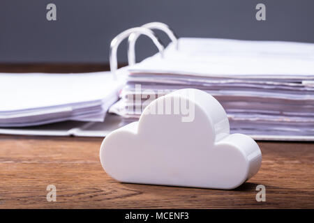 Close-up Of Clouds Block In Front Of Folders On The Wooden Table Stock Photo