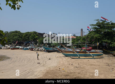 Traditional fishing boats moored at beach, Galle, Sri Lanka, Asia.Òincidental people' outdoor outdoors outside day daylight daytime horizontal 'colour Stock Photo