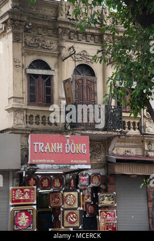 An ornate old building with a shop below selling tacky souvenirs in the Old Quarter, Hanoi, Vietnam, Southeast Asia Stock Photo