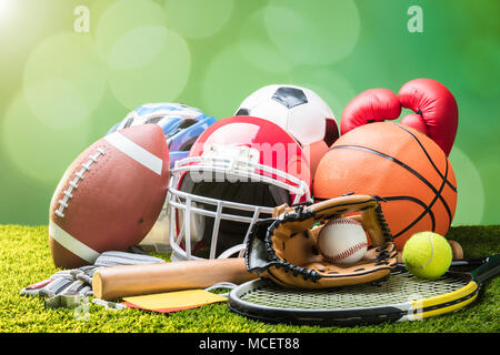 Close-up Of Various Sport Equipments On Pitch Against Bokeh Background Stock Photo