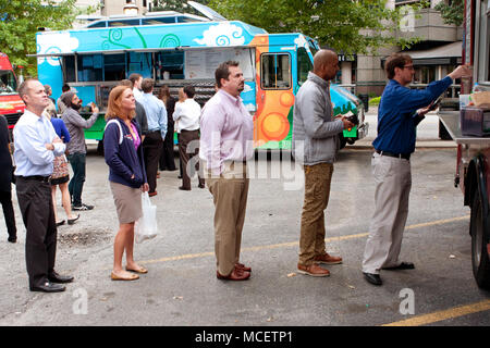 Customers wait in line to order meals from a popular food truck during their lunch hour, at 'Food Truck Thursday on October 16, 2014 in Atlanta, GA. Stock Photo