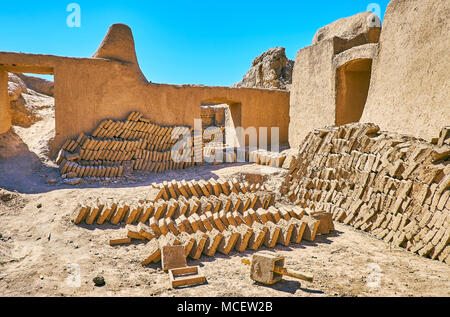 The restoration department of Rayen citadel produces the mud bricks for the needs of ancient archaeological site, finished products are drying in the  Stock Photo