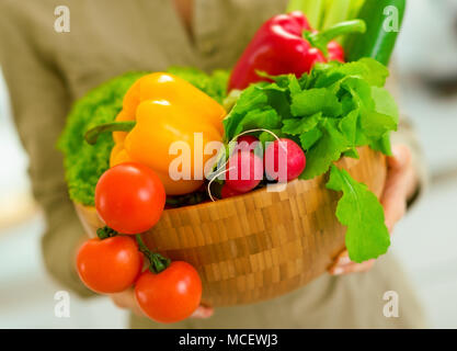 Closeup on plate full of vegetables in modern kitchen in hand of housewife Stock Photo