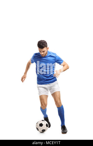 Full length portrait of a soccer player dribbling isolated on white background Stock Photo