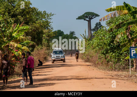 Off-road car on the red track leading to Allee des Baobab in Morondava, Madagascar Stock Photo