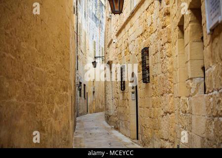Mdina, Malta island. Old medieval city narrow streets, houses sandstone facades and lanterns Stock Photo