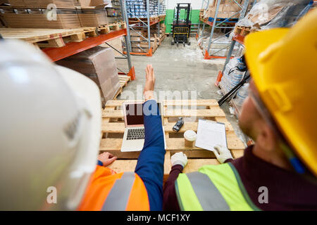 Construction Workers in Warehouse Stock Photo