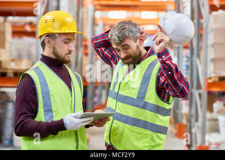 Two Men Working in Warehouse Stock Photo