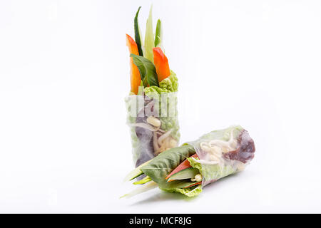 Fresh appetizing spring rolls with vegetables on a white background. Vegetarian. Isolated. Stock Photo