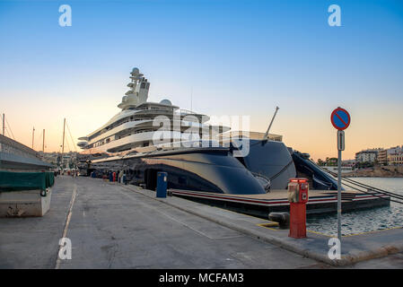 Gigantic big and large luxury mega yacht in marina of Zeas, Greece. Investment for billionaires. Stock Photo