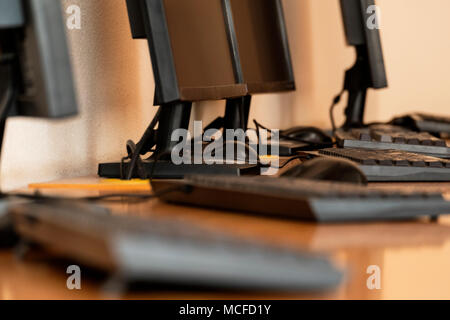 Group of computer neatly placed in a computer lab shallow dof image from table level Stock Photo