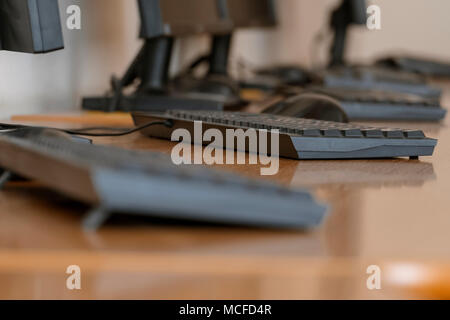 Office interior with computers on tables, shot from low angle with shallow DOF Stock Photo
