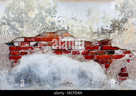 Old plastered wall with red bricks Stock Photo