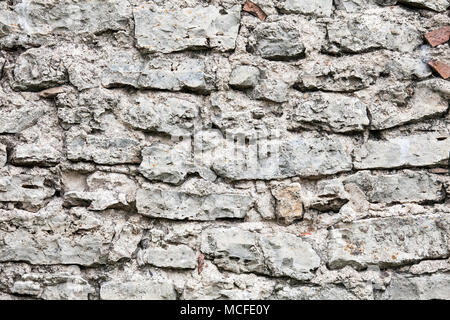 Wall of big stones and broken bricks Stock Photo