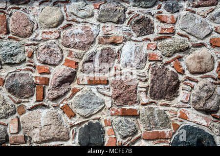 Wall of big stones and broken bricks Stock Photo