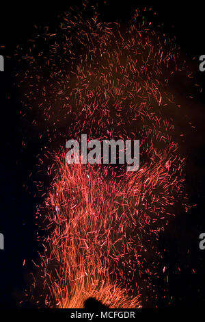 sparks flying into the air from a large bonfire on a winter’s night in the Cevennnes, France Stock Photo
