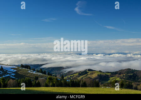 Germany, Above the clouds on a mountain on a sunny day with snow