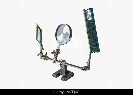 solder helping hands holding DDR memory. looks like a robot or as if it is alive Stock Photo
