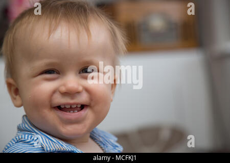 12 month old toddler boy smiling and laughing. Stock Photo
