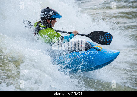 Young female kayaker blasting through the whitewater at Paddle South, the USA Freestyle Kayak National Championship in Columbus, GA. Stock Photo