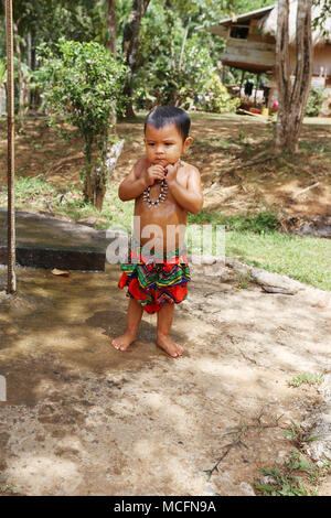 PANAMA, MAR 31: Embera tribal kid taking a shower outdoor dressed with their traditional custome in Panama on March 31, 2018. Stock Photo