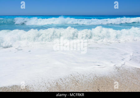 Perfect turquoise water, blue sky and big roling waves on famous Kathisma beach, Lefkada island, Greece Stock Photo