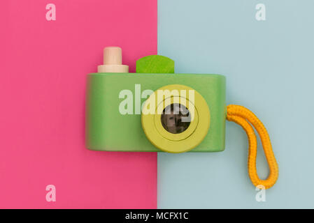 Retro camera on bright pink and blue background Stock Photo