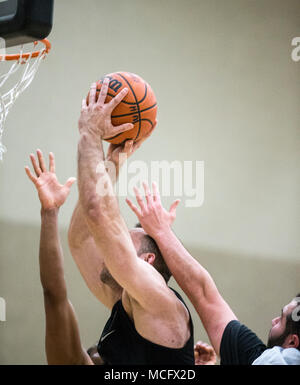 Basketball player taking a shot as he is defended Stock Photo