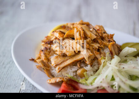 Turkish Chicken Doner Kebab with rice in a white plate. Stock Photo