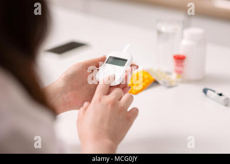 Ill woman controlling blood sugar level Stock Photo