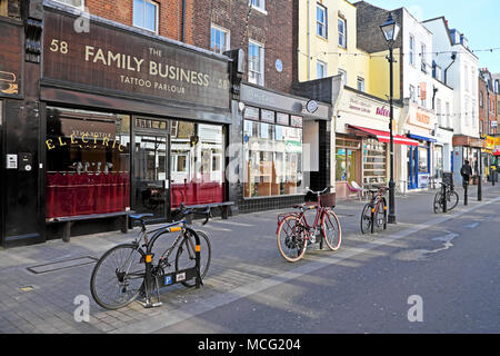 View of row of small traditional shops with bikes parked outside in trendy Exmouth Market Islington, London EC1 England UK  KATHY DEWITT Stock Photo
