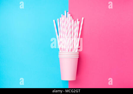 Stacked Drinking Paper Cups with Striped Straws on Duo Tone Mint Blue Pink Background. Flat Lay. Birthday Party Celebration Kids Fun. Greeting Card Po Stock Photo