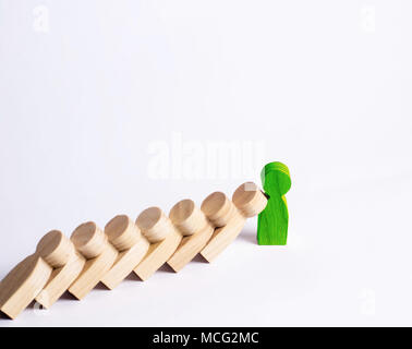 People in line fall like dominoes. Green man stops the fall of people as dominoes. The concept of durability and strength, business ideas. Willpower,  Stock Photo