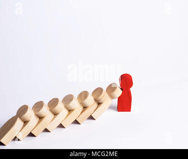 People in line fall like dominoes. Red man stops the fall of people as dominoes. The concept of durability and strength, business ideas. Willpower, st Stock Photo