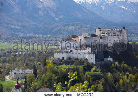 The fortress known as Hohensalzburg above the city of Salzburg on a lovely day set against an Alpine backdrop. Credit: reallifephotos / Alamy Stock Photo