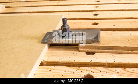 Clamping device on the machine table with cnc. CNC milling machine, wood processing. Joinery, furniture and wooden products. Maintenance and operation Stock Photo