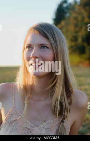A portrait of a woman standing in a field. Stock Photo