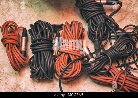 Musical Instrument Cables Pluged In Audio cables for musical instruments and microphones on a white ...