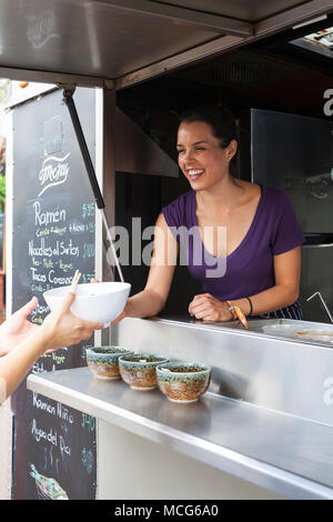 Adria Montaño, chef, serving food from her food truck   Don Ramen, Telefónica Gastro Park Tijuana, Baja California,  Mexico Stock Photo