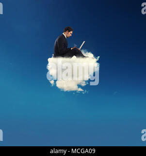 Businessman connected with his laptop over a cloud. concept of social network and internet addiction Stock Photo