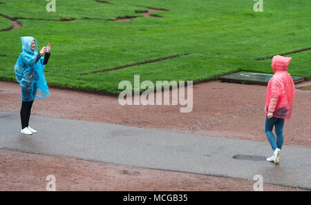 16 April 2018, Germany, Dresden: Two tourists from Russia take photographs in the rain in the courtyard of the Zwinger palace. Photo: Monika Skolimowska/dpa-Zentralbild/ZB Stock Photo