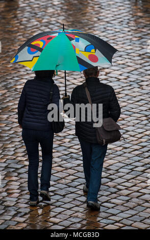 16 April 2018, Germany, Dresden: Tourists with an umbrella in rainy weather in a street in the old town. Photo: Monika Skolimowska/dpa-Zentralbild/ZB Stock Photo