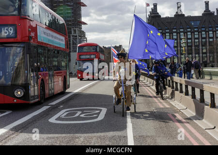 Westminster, London, 16th April 2018. 'EU Elvis' cycles across Westminster Bridge. Anti Brexit activists take to the streets in Westminster. On the day MPs return to Parliament after the Easter Recess,  Anti-Brexit protesters from SODEM (Stand of Defiance European Movement) stage “Super SODEM”. Amongst other things, it features “Wheels for EU” where EU Elvis and other activists on bikes, skates and other wheels whizz around Westminster. Credit: Imageplotter News and Sports/Alamy Live News Stock Photo